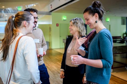 Researchers discussing during conference.